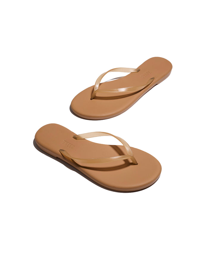 Angled view of both tan TKEES Aqua Sandals showing the sole and side profile.
