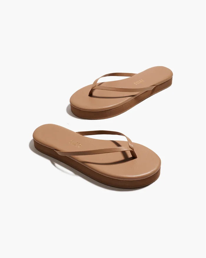 Angled view of both cocobutter TKEES Lily Platform Sandals showing the platform sole and slim thong strap.