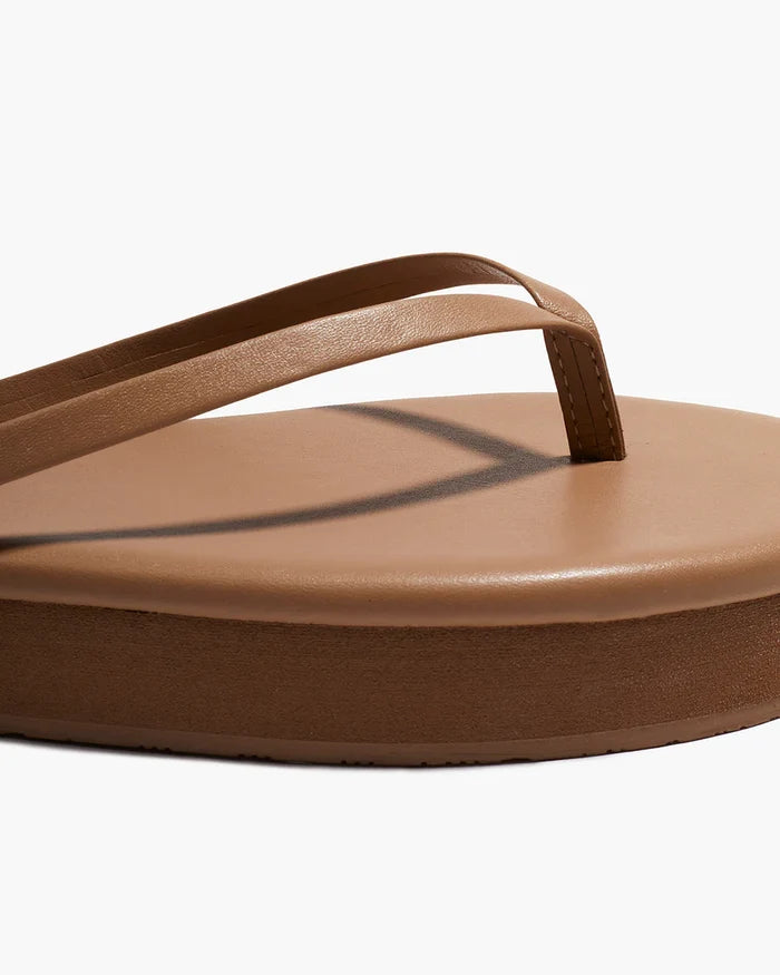 Close-up of the cocobutter thong strap and platform detail on the TKEES Lily Platform Sandals.
