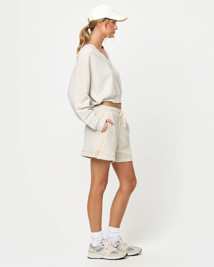LSPACE Vaughn sweatshirt and Bennett Short in heather gray, side view on model.