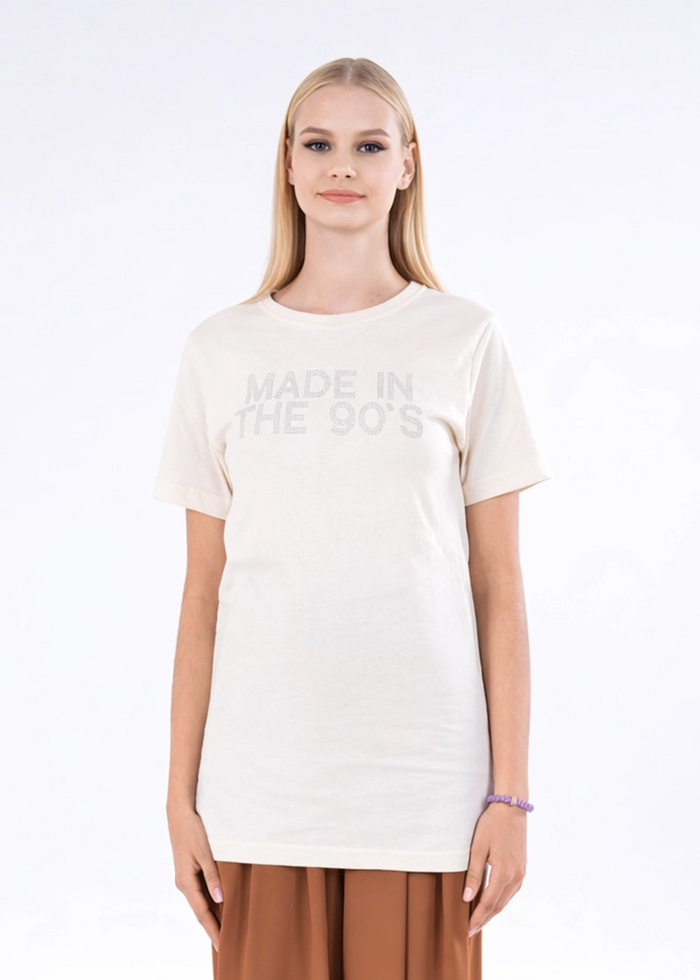 Off-white crewneck top with centered 'MADE IN THE 90'S' print and short sleeves